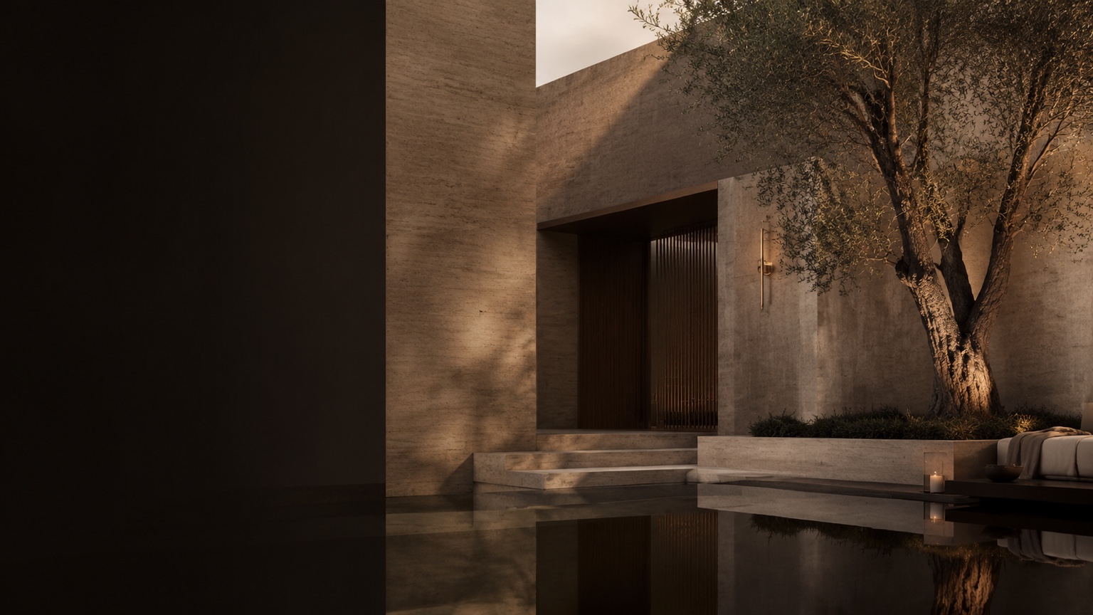 Warm travertine courtyard with an olive tree and still reflecting water at dusk